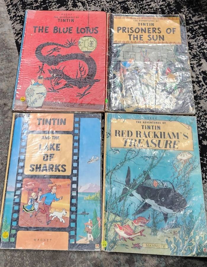 TinTin books x 4 - very collectible - used ex-library books (show wear/ writing in inside cover)